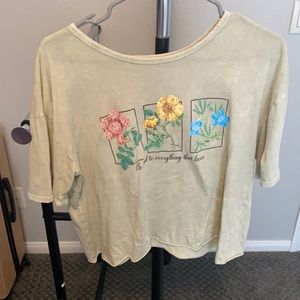 green shirt with flowers & saying